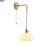 Modern glass copper led wall lights featuring brass-finished sconce with twisted cord and opalescent glass globe