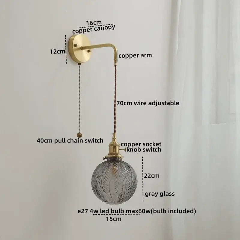 A vintage-style glass copper led wall light with brass copper canopy and adjustable wire featuring gray glass globe