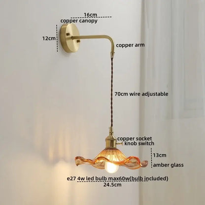 A vintage-style glass copper led wall sconce with amber wavy glass shade and integrated led bulb for bedroom wall lights