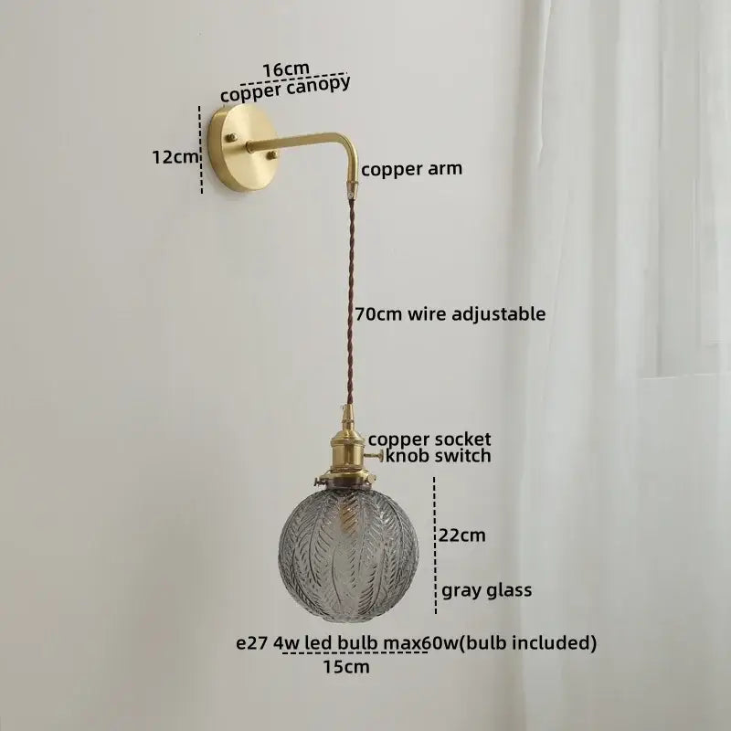 Modern glass copper led wall sconce with brass-finished copper arm and adjustable wire suspending textured gray glass globe