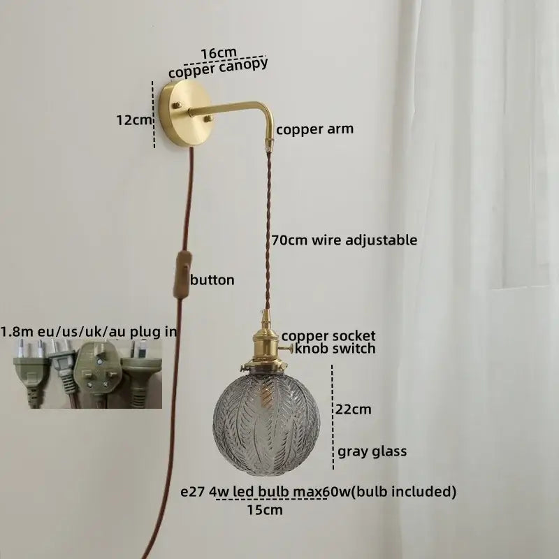 Modern glass copper led wall lights feature a brass-finished copper arm with gray etched glass globe for bedroom use