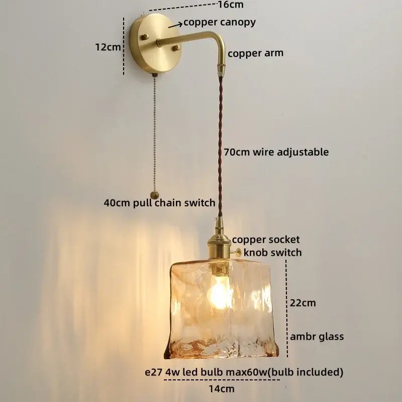 A warm amber glass copper led wall light with textured hand-blown finish and brass copper led wall arm canopy