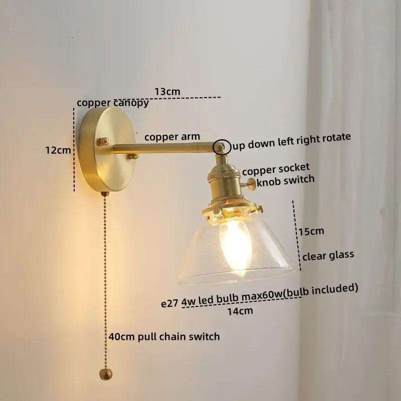 Brass-finished copper led wall light with clear glass shade and adjustable arm for modern bedroom reading use