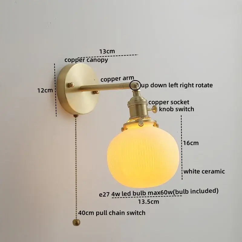 Vintage-style wall lights with a brass-finished copper led arm and warm white ceramic globe for bedroom reading