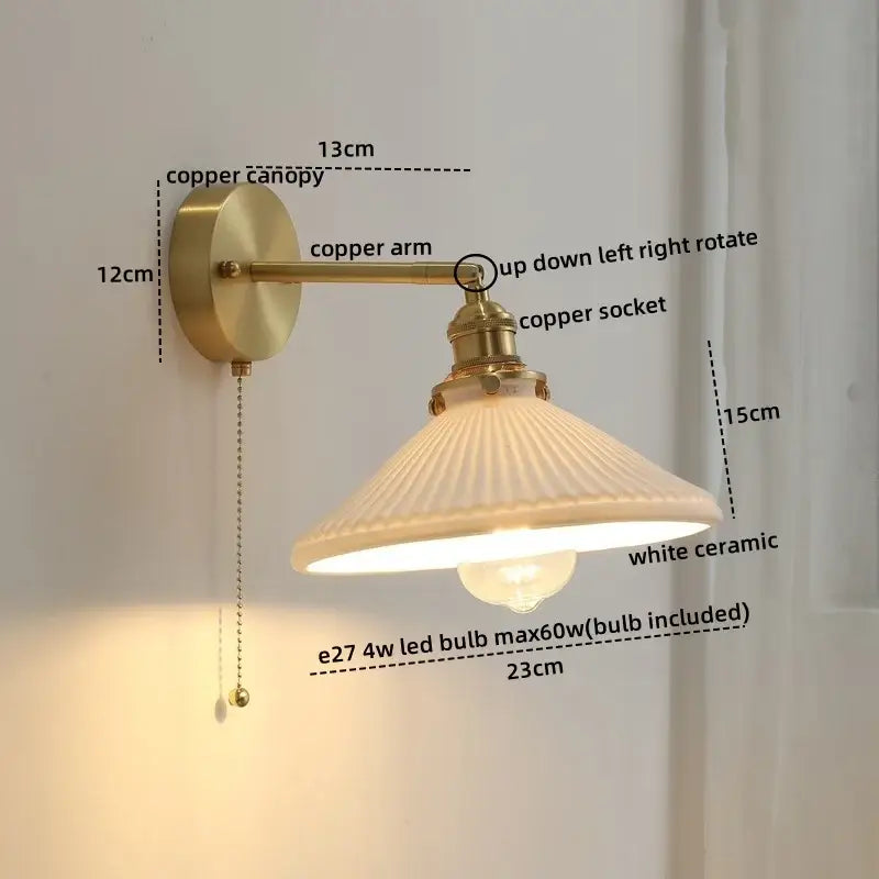 A vintage-style wall light with brass-finished copper arm and adjustable socket featuring a white ceramic shade