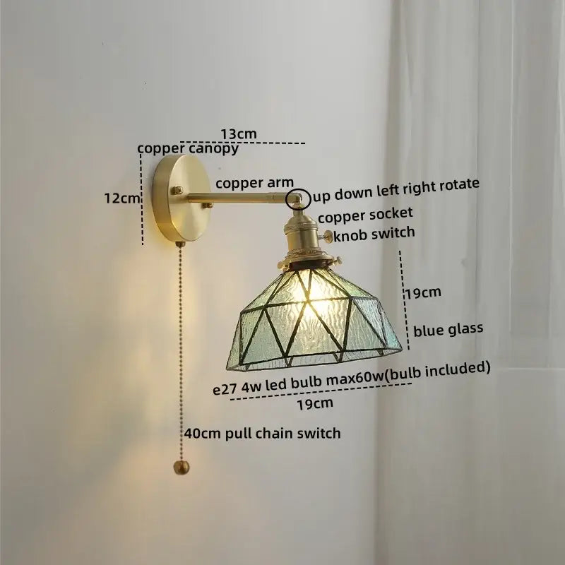 Vintage-style wall lights with brass-finished copper led arm and geometric blue glass copper led shade for bedroom reading