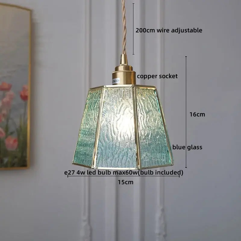 Modern glass copper pendant light with textured blue glass panels and brass frame for dining room or kitchen island
