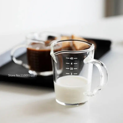 Modern glass cup with wooden handle measuring jug filled with milk as a milk latte jug kitchen tool