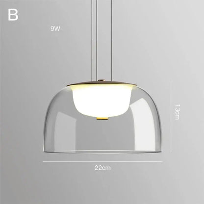 Modern glass pendant light with clear glass dome, warm white led bulb, brass accents, ideal for dining room wood fixture
