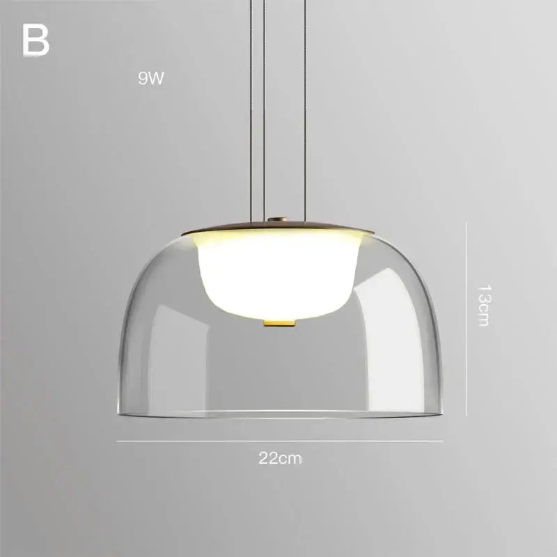 Modern glass pendant light with clear glass dome, warm white led bulb, brass accents, ideal for dining room wood fixture