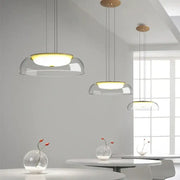 Modern glass dome pendant lights with warm yellow illumination and wooden ceiling fixture for dining room use