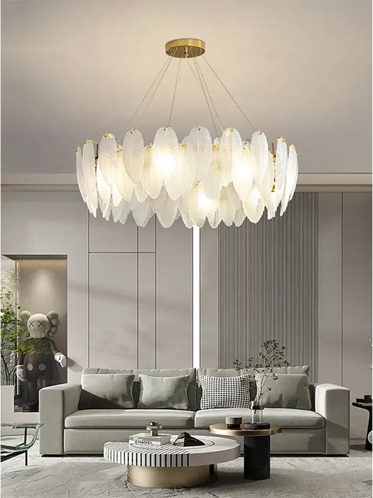 A modern glass feather chandelier with translucent leaf-shaped panels and brass fixture for living room pendant lighting