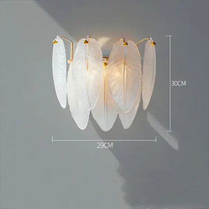 Elegant white feather chandelier wall sconce with gold-toned brass accents for modern living room decor