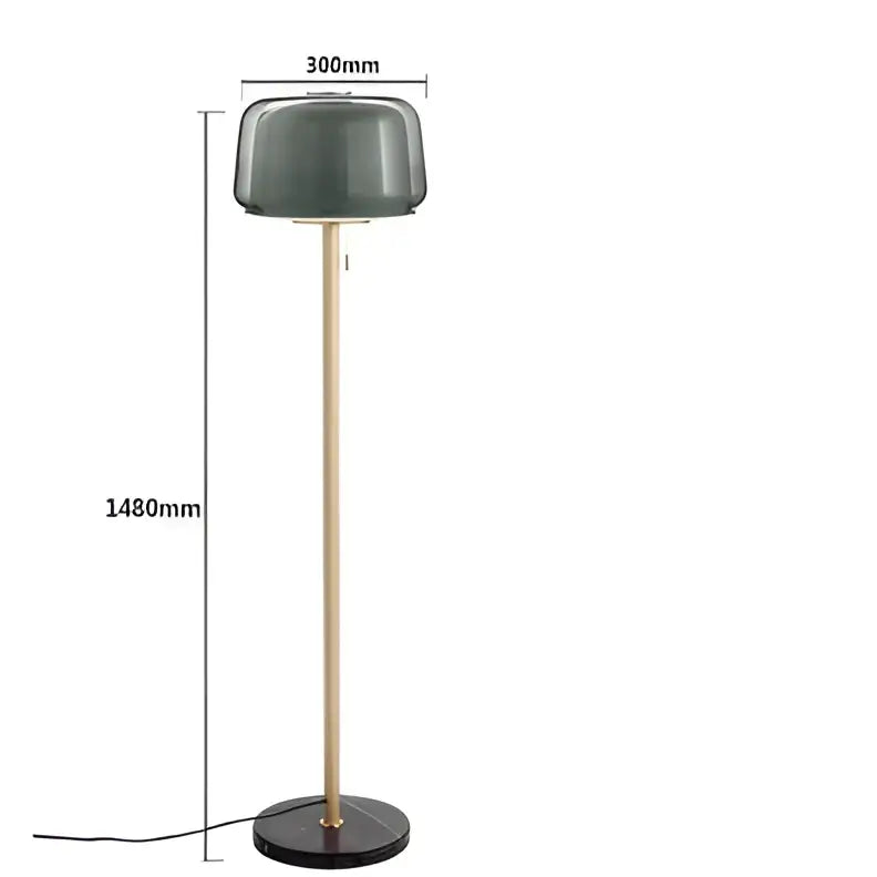 Modern glass floor lamp with a matte dark green glass shade and slender brass-finished pole for living room use