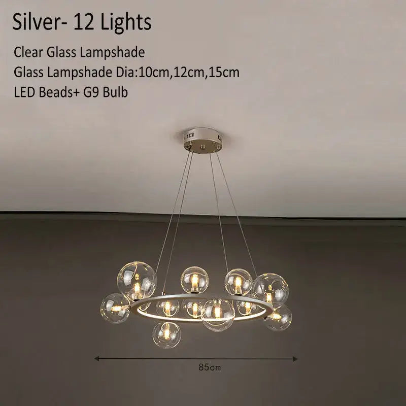 Modern glass chandelier lamp with twelve clear glass lampshades suspended from a silver circular frame for kitchen island lighting