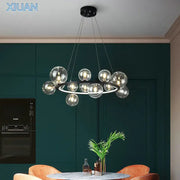Modern glass chandelier lamp with sleek black circular frame and hanging transparent spheres for kitchen island lighting