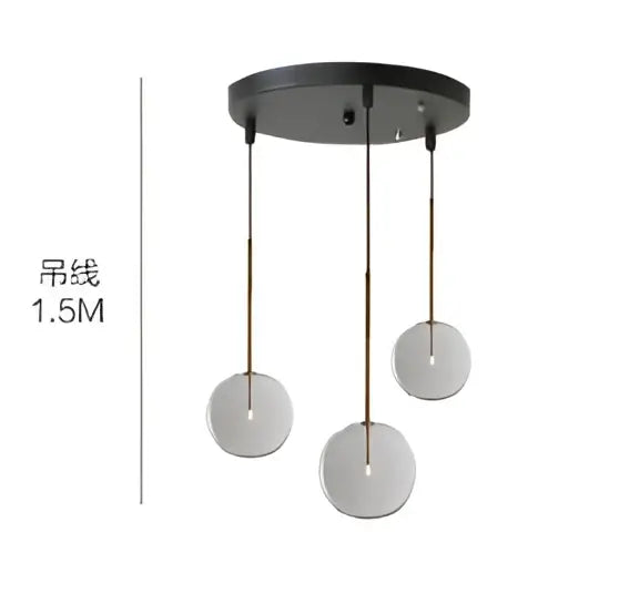 Black circular ceiling fixture with three hanging glass globe chrome shades in modern pendant light design