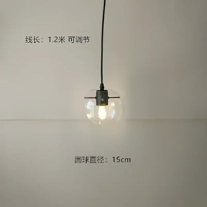 Modern glass globe chrome pendant light with clear spherical glass globe and black metal fixture for dining room use