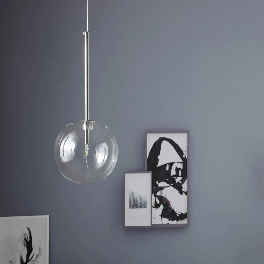 Modern glass globe chrome pendant light with clear glass globe and sleek chrome-finished rod for dining room lighting