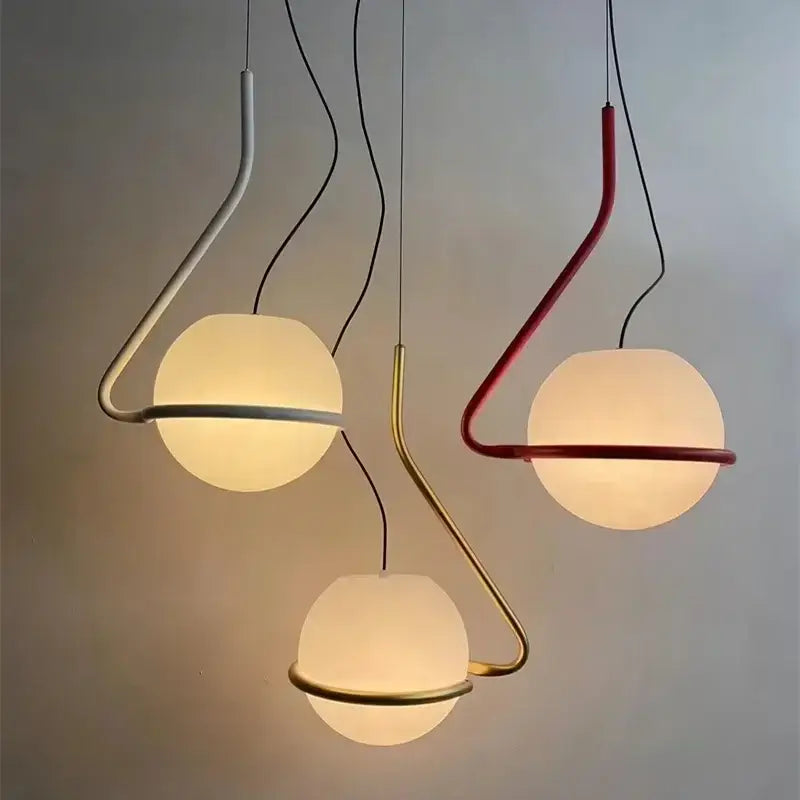 Three modern pendant lamps with frosted glass globe shades and curved metal frames in white red and gold for kitchen island decorbites glass globe pendant