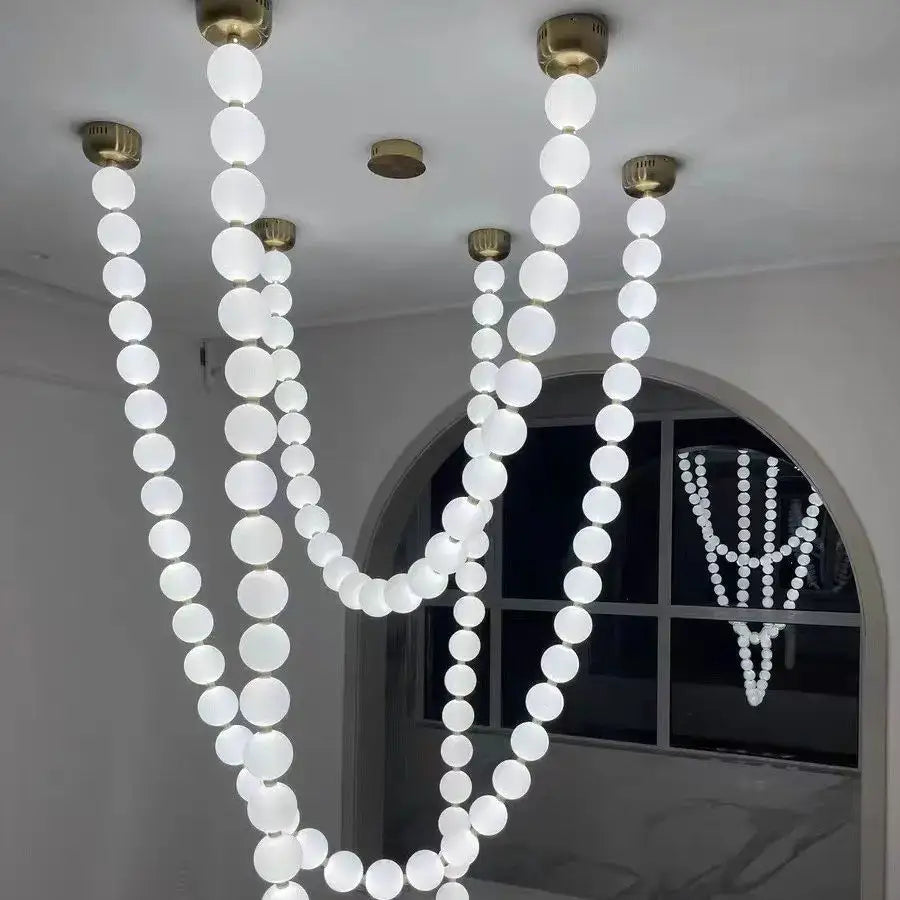 A modern glass gold pendant light with frosted white bulb strands and brass-finished fixtures for living room decorbites glass gold