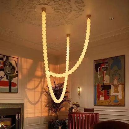 A modern glass gold pendant light with warm spherical bulbs in a flowing v-shaped design for living room decorbites glass gold pendant