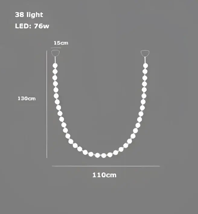 A sleek white led string light with 38 bulbs curving under a modern glass gold pendant light decorbites glass gold