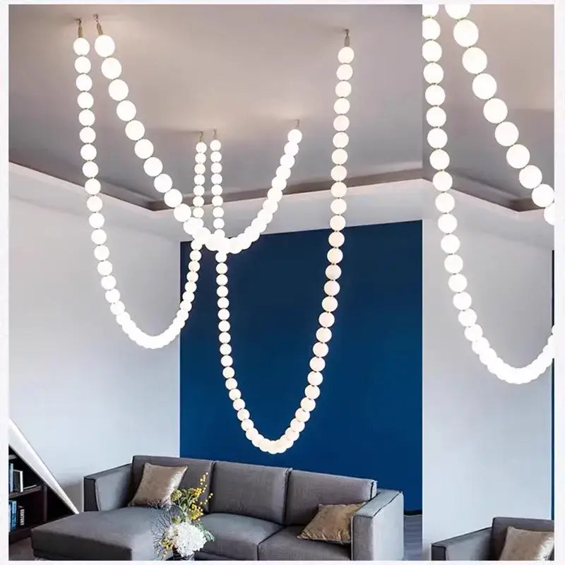 Modern white spherical pendant light with glass gold accents suspended in cascading strands for elegant decorbites decor