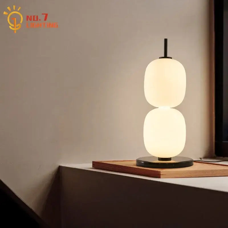Modern glass gourd table lamp with two stacked oval glass shades on a marble base ideal for bedroom lighting decorbites glass gourd