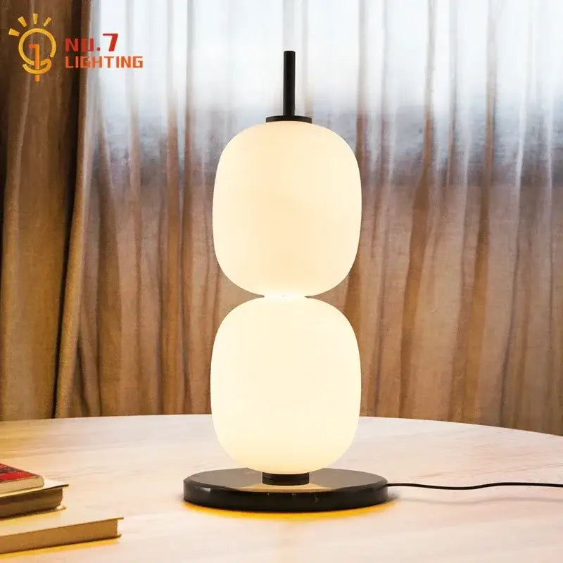 Modern glass gourd table lamp with two frosted glass shades and marble base emitting warm ambient light for bedroom decorbites glass gourd