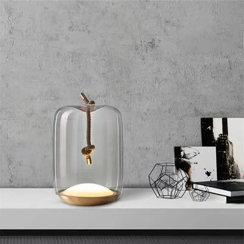 Modern glass knot table lamp with brass base and rope-hung bulb by decorbites brokis knot for bedroom decor