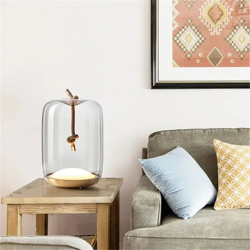 Modern glass knot table lamp with a clear glass bell jar and brass base rope hung pendant for bedroom decorbites brokis knot