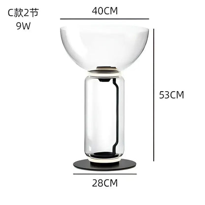 Modern glass led floor lamp with a clear glass bulbous top and cylindrical base featuring glowing rings for living room