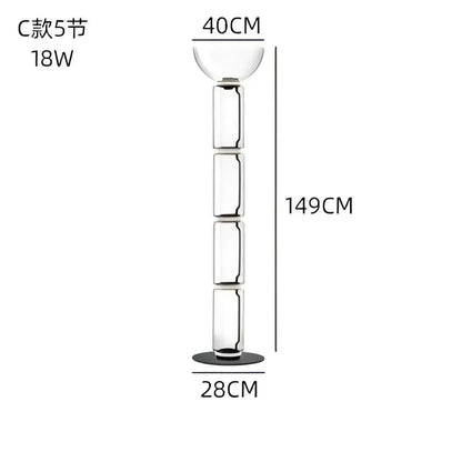 A tall slender modern glass led floor lamp with clear cylindrical body and glowing rings for living room use