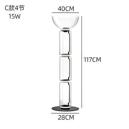 Modern glass led floor lamp with tall transparent segmented glass candle holder and black base for living room use