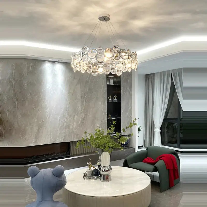 A modern pendant light featuring clear glass orb crystals in a circular decorbites crystal magic ring design
