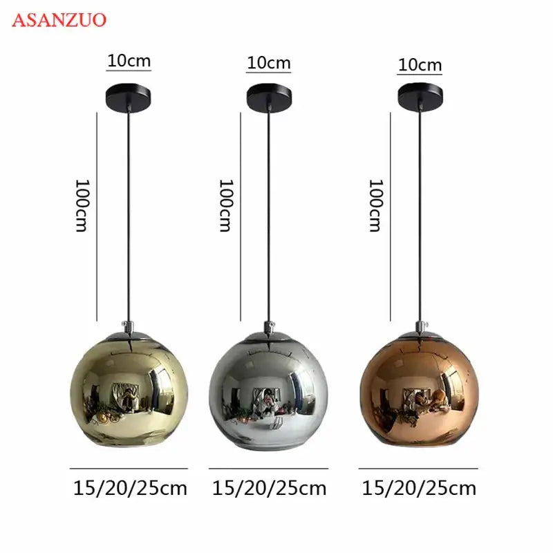 Three spherical glass pendant lights by asanzuo with metallic gold silver and copper finishes for modern kitchens
