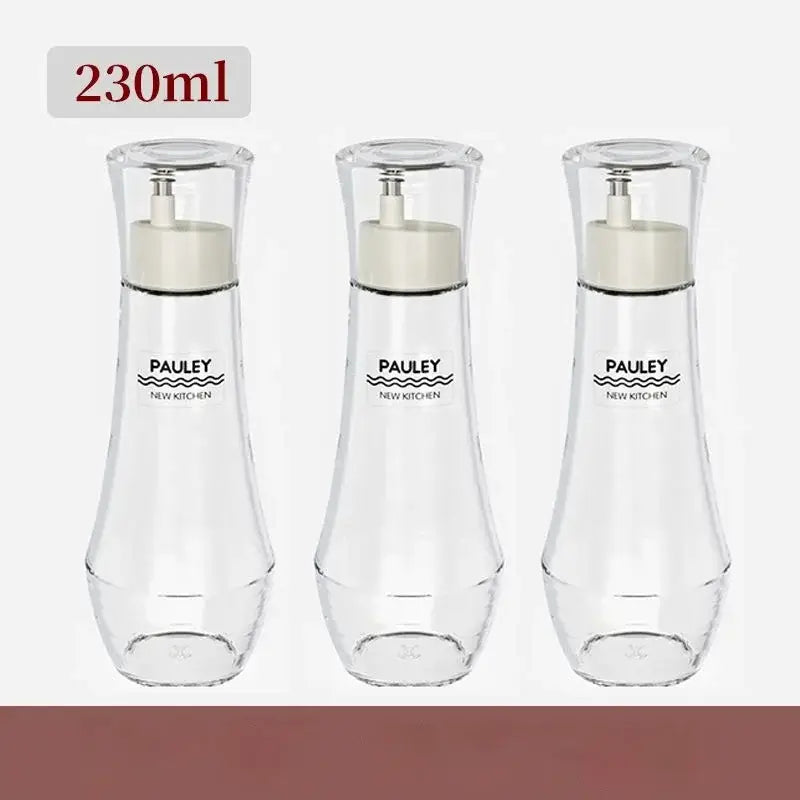 Three transparent glass seasoning bottles with 230ml capacity and cream-colored pump tops in a modern seasoning bottle set