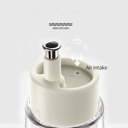 Cream-colored plastic air intake lid with metallic silver spout on a clear glass base in a modern glass seasoning bottle set