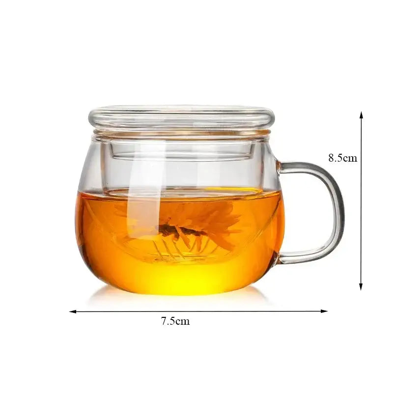 Modern glass tea cup with infuser and lid featuring clear glass tea cup and golden-brown brewed tea inside