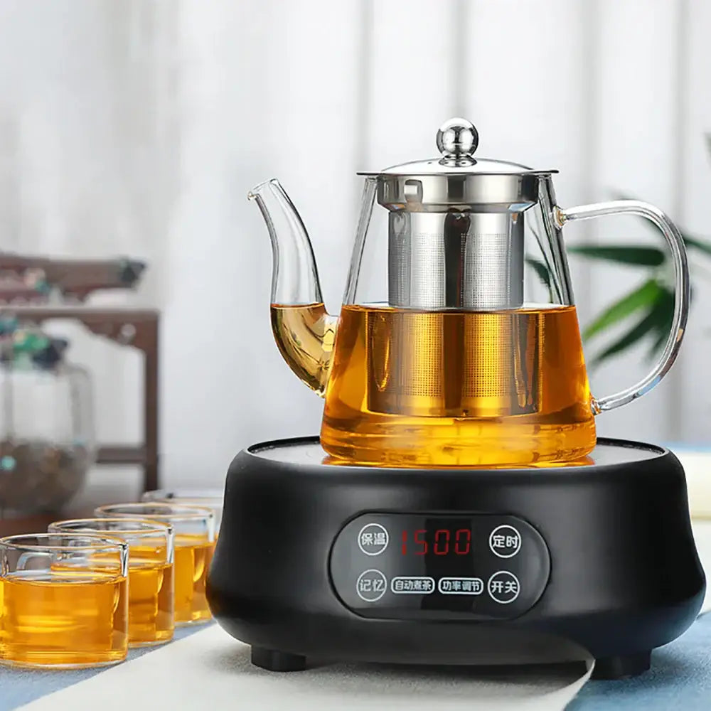 Modern clear glass tea infuser pot with stainless steel lid and built-in filter filled with amber tea