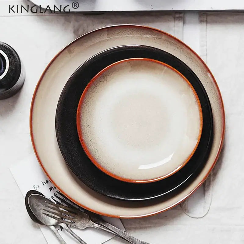 Set of three modern glazed ceramic round plates in black and beige with a rustic handcrafted finish by decorbites ceramic round plate
