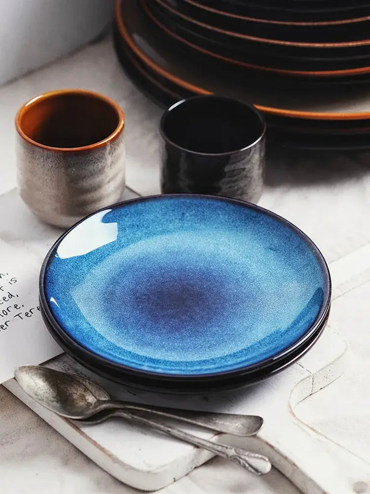 A vibrant blue decorbites ceramic round plate with gradient glaze and subtle speckled texture for dining use
