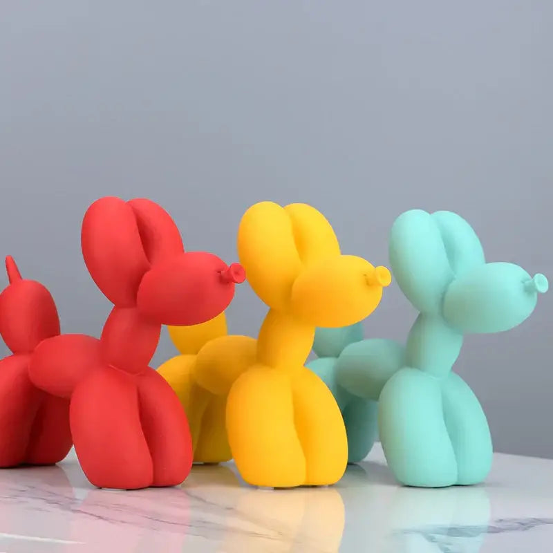 Vibrant glossy red yellow and teal balloon dog sculpture figurines suitable for modern living room decor