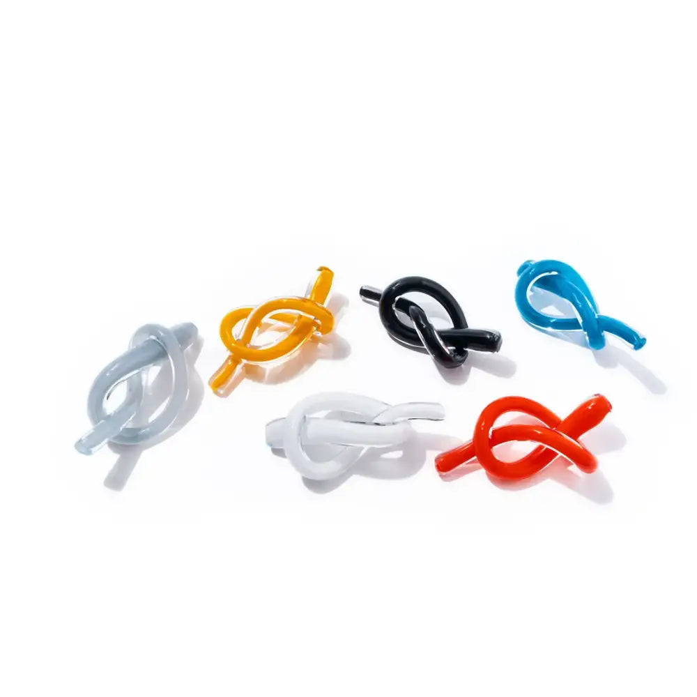 Modern glossy black geometric glass sculpture and colorful knot-shaped glass clips for living room decorbites geometric glass