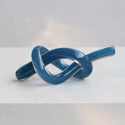 A modern glossy blue glass sculpture twine with transparent sections for geometric glass decorbites living room decor