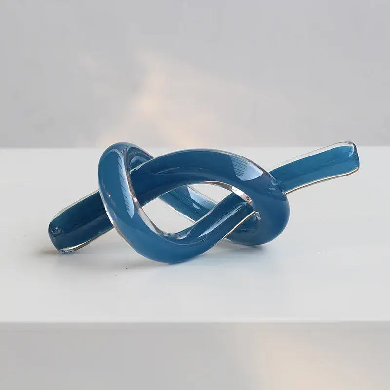 A modern glossy blue glass sculpture twine with transparent sections for geometric glass decorbites living room decor