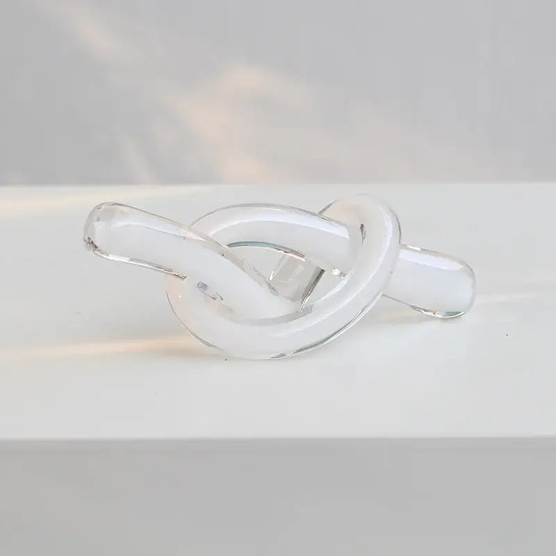 Clear glass knot decor featuring geometric glass sculpture twine for modern glossy black living room decorbites design