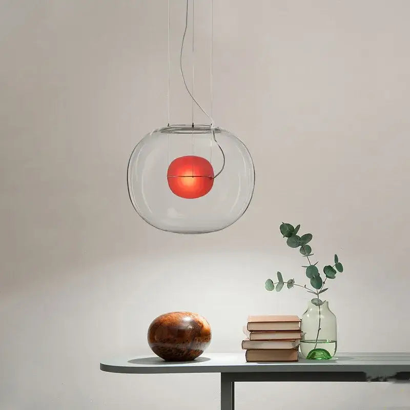 Modern glossy black glass ball pendant light with clear globe and glowing red bulb for dining room decorbites brokis big