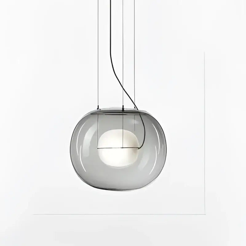Modern glossy black glass ball pendant light featuring a sleek translucent gray glass pendant light with visible bulb decorbites brokis big